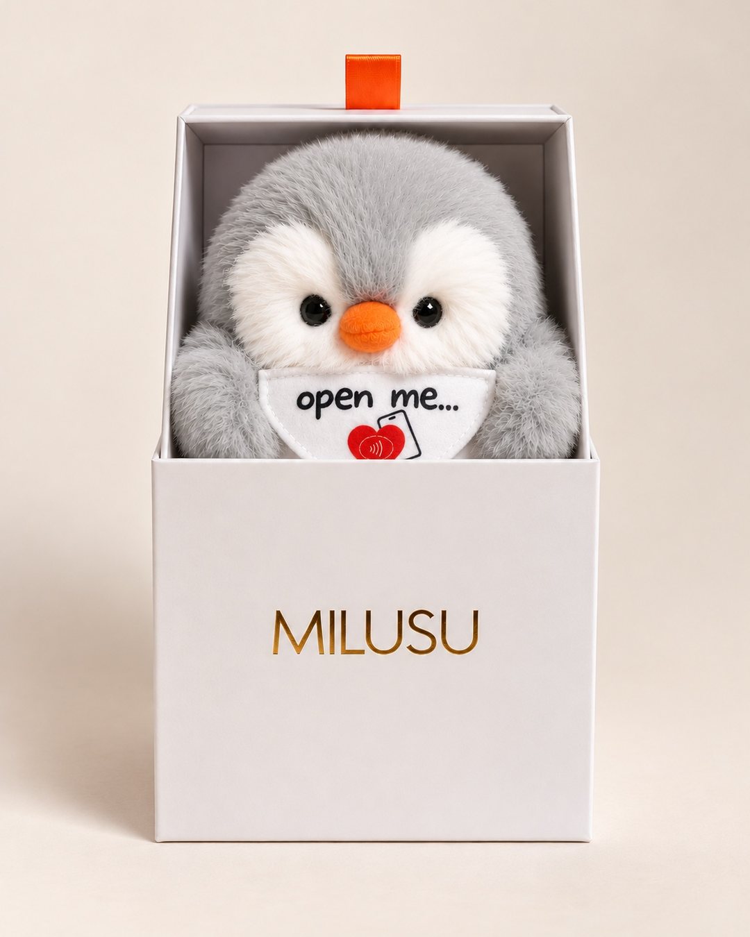 Grey MILUSU penguin peeking out of its open white MILUSU gift box